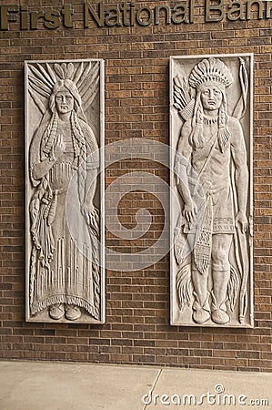 Beige stone mural of native couple in Sioux Falls, SD, USA Editorial Stock Photo