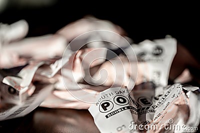 Sioux Falls, South Dakota, USA - 11.2022 - pile of wadded up and crumpled losing Powerball Lottery tickets. Editorial Stock Photo