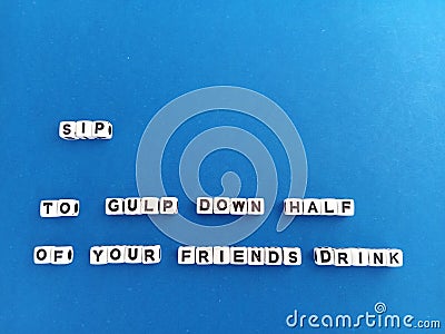 Sip to gulp down half of your friend's drink on a blue background Stock Photo