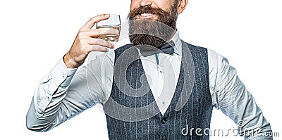 Sipping finest whiskey. Stylish rich man holding a glass of old whisky. Bearded gentleman drink cognac Stock Photo