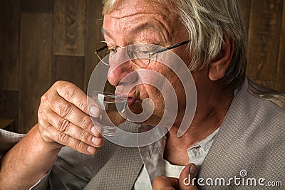 Sipping a shot glass Stock Photo