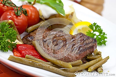 Sirloin Strip Steak with green beans,tomato,pepper Stock Photo