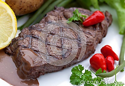 A sirloin strip steak with vegetables and savory Stock Photo