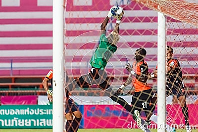 SISAKET THAILAND-MAY 24: Mfeyet Njoya Souleymane of Sisaket Utd. (green) in action during Regional League between Sisaket Utd. an Editorial Stock Photo