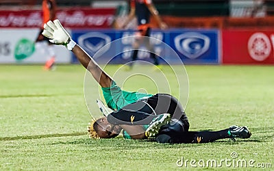 SISAKET THAILAND-MAY 24: Mfeyet Njoya Souleymane of Sisaket Utd. (green) in action during Regional League between Sisaket Utd. an Editorial Stock Photo