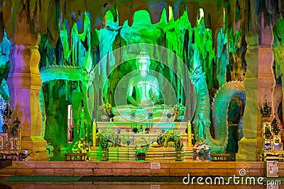 SISAKET, THAILAND - May 18, 2023: People visit the Statue of Naka and the beautiful white Buddha at Wat Pa Si Mongkhon Rattanaram Editorial Stock Photo