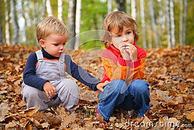 Sister with brother children in autumn park Stock Photo