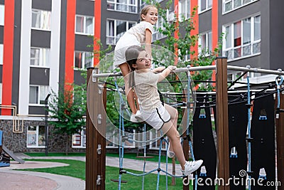 sisterhood, friendship. two charming teen girls having fun on a modern playground. sister, bffs communication Stock Photo