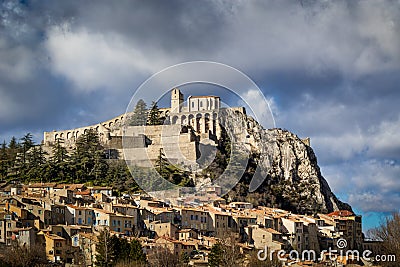 Sisteron Citadel, fortifications and rooftops with clouds. Southern Alps, Franc Stock Photo