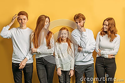Sisters, brothers with natural red hair posing at camera Stock Photo