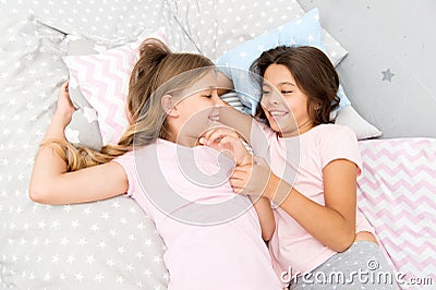 Sisters happy small kids relaxing in bedroom. Friendship of small girls. Leisure and fun. Having fun with best friend Stock Photo