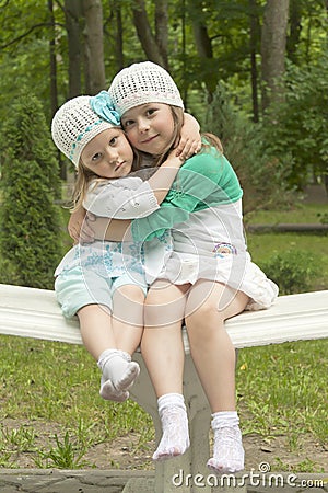 Sisters in park on a bench Stock Photo