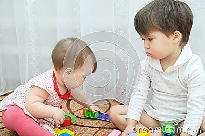 Sisters playing. Two little girls, baby and toddler. jealous child Stock Photo