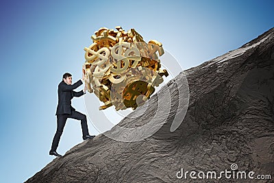 Sisyphus metaphore. Young businessman is maximizing earnings and pushing heavy boulder made of dollar symbol up on hill Stock Photo