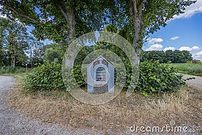 Sittard, South Limburg / Netherlands. August 4, 2020. Small chapel of Our Lady of Sorrows between two huge trees Editorial Stock Photo