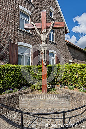 Sittard, South Limburg / Netherlands. August 4, 2020. Wooden cross with the statue of Jesus crucified on a brick base Editorial Stock Photo