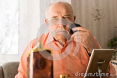 Sitting Elderly Shaving his Beard Using Razor Stock Photo