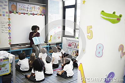 Sitting on the floor listening to story telling Stock Photo