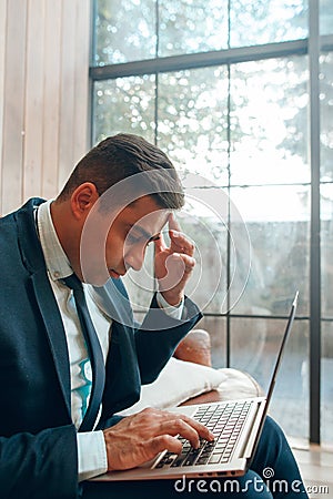 Sitting man looking at laptop screen Stock Photo