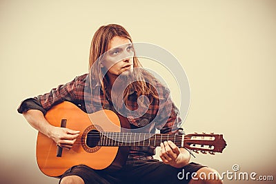Sitting man playing guitar. Stock Photo