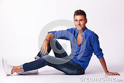 Sitting relaxed on floor & smiling Stock Photo