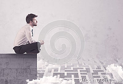 Sitting salesman on rooftop solving maze Stock Photo