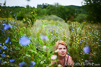 Sitting in wildflowers field Stock Photo