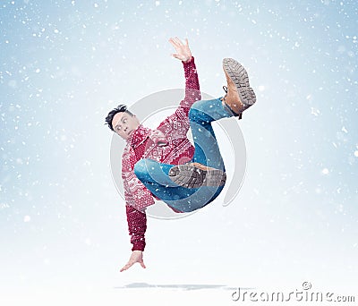 Situation, the man in a red sweater with a scarf is falling, around the snow. Concept of an accident Stock Photo