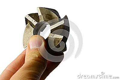 Six blade shell type face milling cutter tool from high speed steel, slightly used, held in fingers of left hand, white background Stock Photo