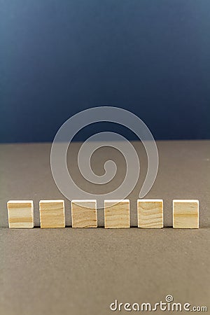 Six children wooden blocks in line, portrait Stock Photo