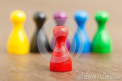 Six colored pawns, red in front Stock Photo