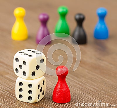 Six colored pawns and two dice Stock Photo