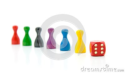 Six colorful pawns with red dice Stock Photo