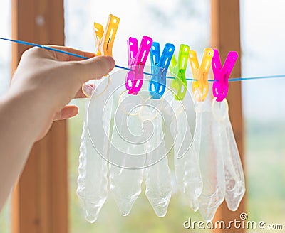 Six condoms drying on the rope. Stock Photo