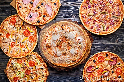 Six different pizza set for menu on the wooden table. Italian fo Stock Photo