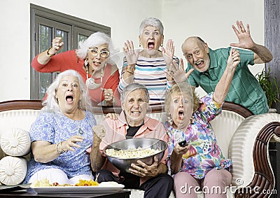 Six Excited Friends Reacting to Television Stock Photo