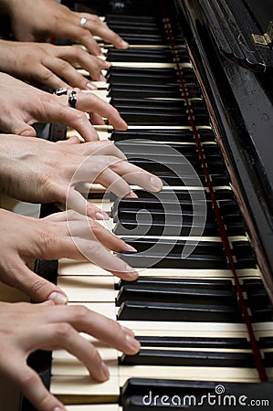 Six hands on piano Stock Photo