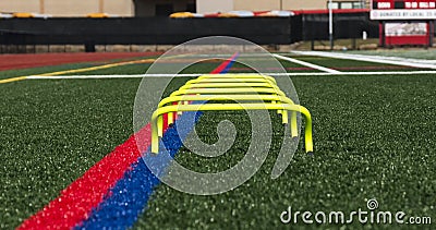 Six inch yellow banana step hurdles on a turf field Editorial Stock Photo