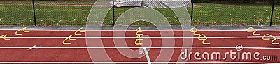 Six inch yellow hurdles set up on a track for sprinter to run over Stock Photo