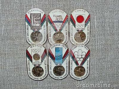 Six metal badges depicting the Olympic medal and the inscription-Soviet athletes at the Olympic games Editorial Stock Photo