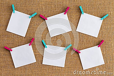 Six misaligned blank white notepads on hessian Stock Photo