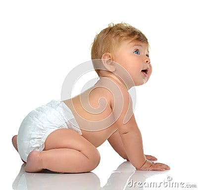 Six month infant child baby toddler sitting in diaper looking at Stock Photo