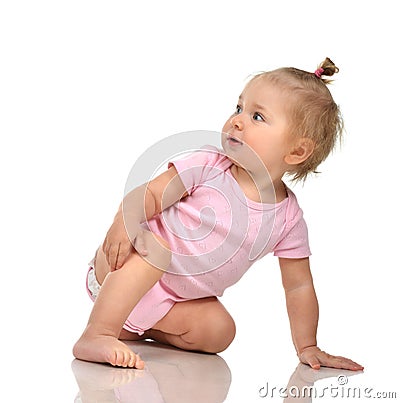 Six month infant child baby toddler sitting in pink body and diaper Stock Photo