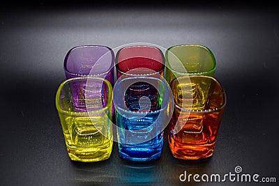 Six multicolored shot glasses on black background Stock Photo