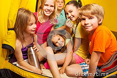 Six nice children, boys and girls sitting in tent Stock Photo