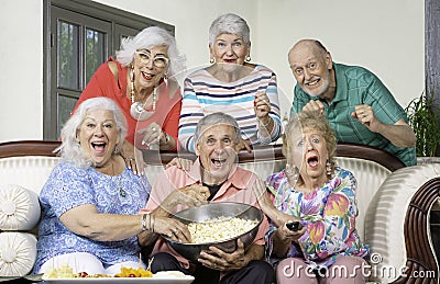 Six Senior Friends Reacting to Television Stock Photo