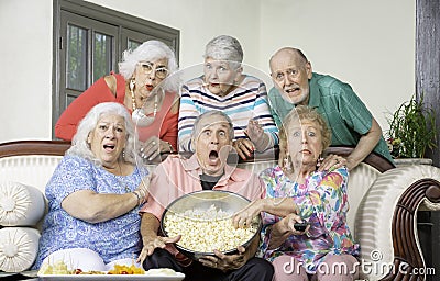 Six Shocked Friends Reacting to Television Stock Photo