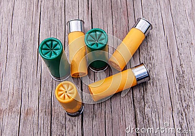 Six shotgun shells, four yellow and two green ones Stock Photo