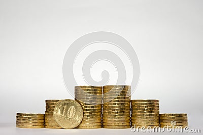 Six stacks of coins increasing height symmetrically on a white background, pockmarked stands on the edge of the Russian 10 ruble c Stock Photo