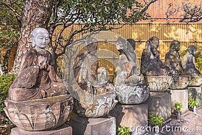 Six statues of sitting Jizo bodhisattva or Jizo Bosatsu in the Tamonji Temple. Editorial Stock Photo